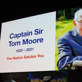 A tribute to Captain Sir Tom Moore, who has died at the age of 100 after testing positive for Covid-19, is broadcast on the Piccadilly Circus lights, in central London. PA.