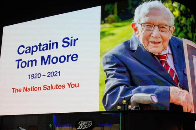 A tribute to Captain Sir Tom Moore, who has died at the age of 100 after testing positive for Covid-19, is broadcast on the Piccadilly Circus lights, in central London. PA.