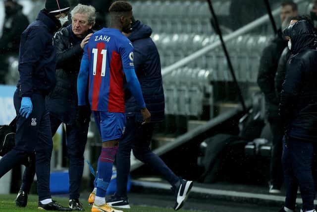 SETBACK: Crystal Palace forward Wilfried Zaha goes off injured in Tuesday night's 2-1 victory at Crystal Palace. Photo by Lee Smith - Pool/Getty Images.