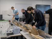 Staff unpack and set up laptops delivered to Leeds City College.