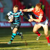 Rob Burrow gets past Hull KR's Kris Welham during the opening game of the 2015 Super League season. Picture: Tony Johnson.