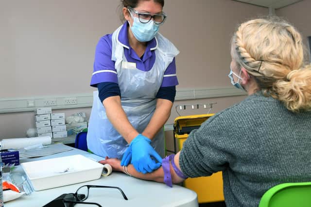 A nurse carries out a health check on one of the volunteers participating in the Novavax Covid-19 vaccine trials in Leeds. Picture: Jonathan Gawthorpe