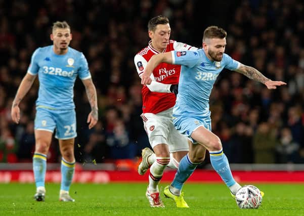 Stuart Dallas gives Mesut Ozil the runaround the last time Leeds United visited the Emirates, in the FA Cup just over a year ago.  Picture: Bruce Rollinson.