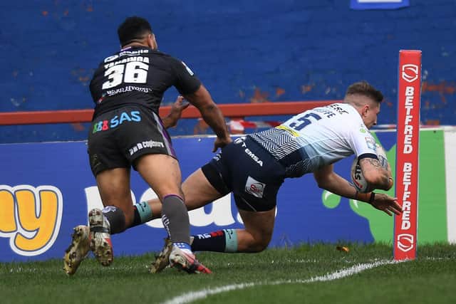 Ash Handley gets past Kelepi Tanginoa to score for Leeds in their win at Wakefield last November. Picture by Jonathan Gawthorpe.