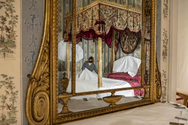 Reflected in a mirror, conservator Emma Bowron wrapping up the bed gifted by the Prince of Wales to Isabella Anne Shepherd Ingram, Marchioness of Hertford in the early 1800s. Picture: Tony Johnson