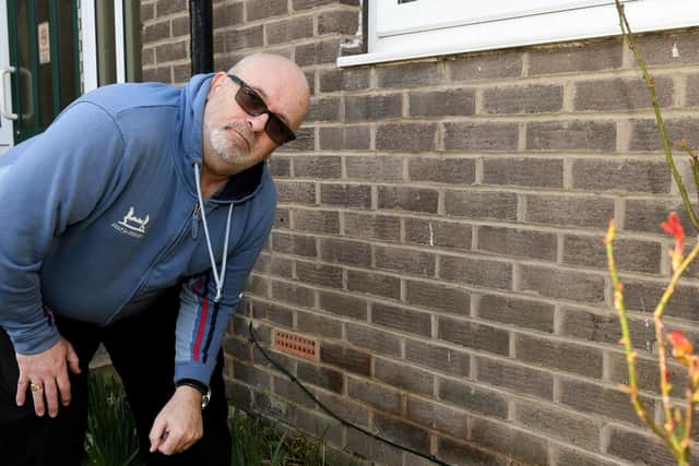 The man says serious damp has forced him to sleep on a camp bed