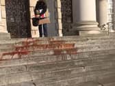 Extinction Rebellion protesters throwing fake 'blood' on the steps of Leeds Civic Hall.