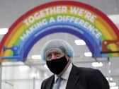 Prime Minister Boris Johnson, wearing a face mask, during a visit to a PPE manufacturing facility in Seaton Delaval (photo: PA).
