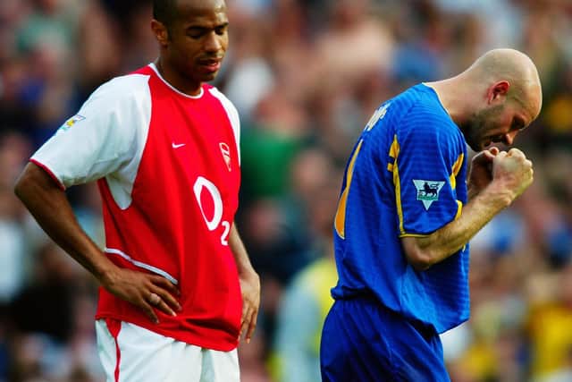 JOY AND PAIN: Leeds United's Danny Mills, right, celebrates the 3-2 win at Arsenal of May 2003 as Gunners legend Thierry Henry, left, shows his despair at a defeat that handed Manchester United the title. Photo by Ben Radford/Getty Images.