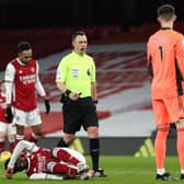 MISTAKE: Leeds United goalkeeper Illan Meslier, right, looks on as referee Stuart Attwell marches forward to point to the penalty spot after Meslier's foul on Arsenal's Bukayo Saka, left. Photo by Catherine Ivill/Getty Images.