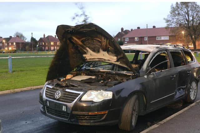 VW Passat burned out on Cardinal Square, Beeston, after drive-by shooting on Back Maud Avenue.
