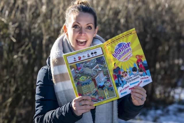 Hazel Merlino, managing director at Rainbow Factory, with one of its adventure books. Picture: Tony Johnson