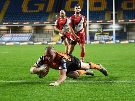 Grant Millington scores for Tigers against Salford last season. Picture by Jonathan Gawthorpe.