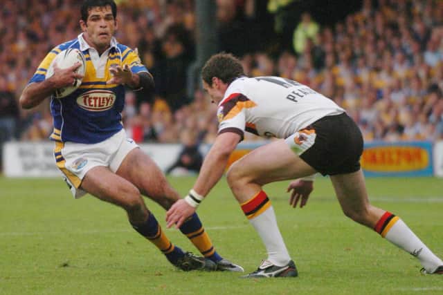 Chris McKenna evades Jamie Peacock in a 2005 Rhinos-Bulls derby. Both players are among Leeds' 50 Grand Final winners. Picture by Dan Oxtoby.