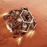 Artist impression issued by NASA of NASA's Perseverance rover firing up its descent stage engines as it nears the Martian surface