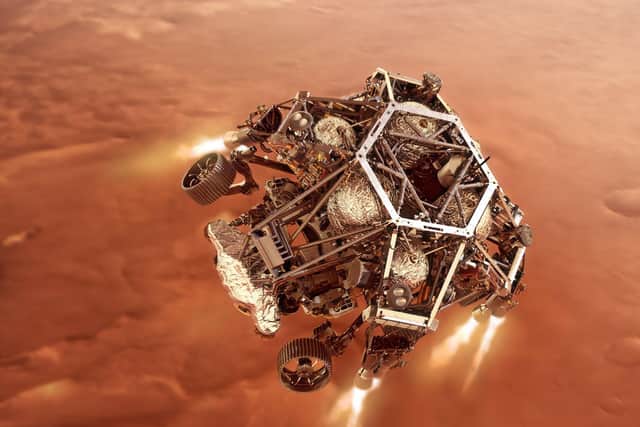 Artist impression issued by NASA of NASA's Perseverance rover firing up its descent stage engines as it nears the Martian surface
