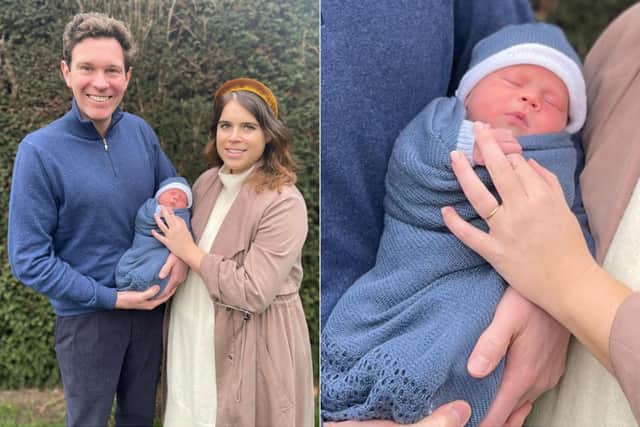 The couple are pictured smiling with their first child, in an image released by Buckingham Palace