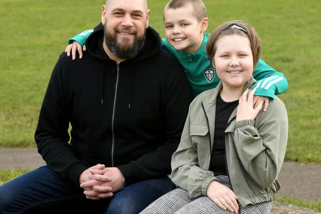 Leeds United's matchday pitch announcer Leigh Nicholson, 42, with his 10-year-old son Jack and 12-year-old daughter Ruby