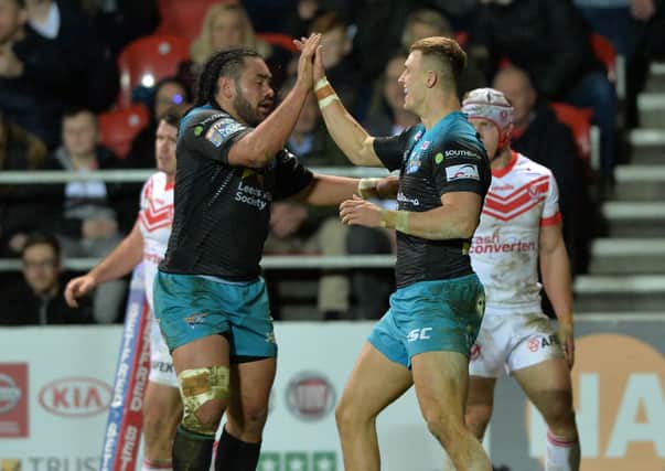 HIGH FIVE: Ash Handley celebrates with Konrad Hurrell after scoring the Rhinos' third try against St Helens on this day in 2019. Picture: Bruce Rollinson.