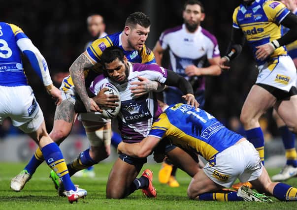 WRAPPED UP: Melbourne Storm's Sisa Waqa is tackled by Leeds Rhinos' Brett Delaney (left) and Carl Ablett during the World Club Challenge in 2013. Picture: Anna Gowthorpe/PA Wire.