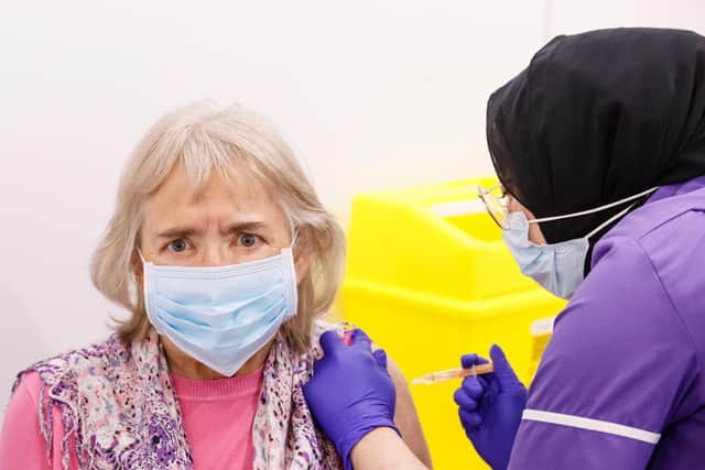 Maureen Mitson, aged 72, received an injection of the the Oxford/AstraZeneca coronavirus vaccine from NHS nurse Maha Mutardi at the Elland Road vaccination centre in Leeds (photo: PA Wire/ Danny Lawson)