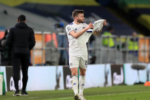 FOR YOU: Leeds United's Stuart Dallas holds up a Whites shirt with 'Granny Val' on the back of it in tribute to Kalvin Phillips' late grandmother Val Crosby. Photo by Mike Egerton - Pool/Getty Images.