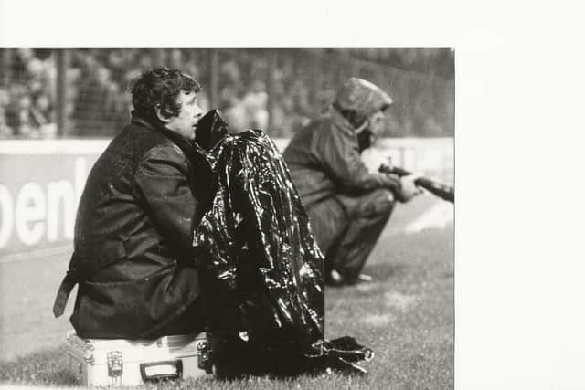 Photographer Bill Hirst working at a football match