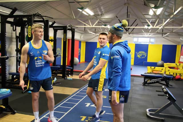 Harry Newman, left, in Rhinos' Kirkstall gym with teammate Callum McLelland and assistant-coach Chev Walker. Picture by Phil Daly/Leeds Rhinos.