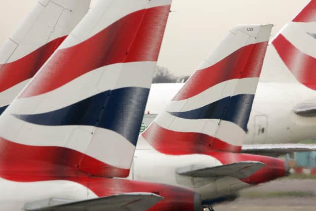 Library image of tail fins of British Airways' aircraft parked at Terminal One of Heathrow Airport