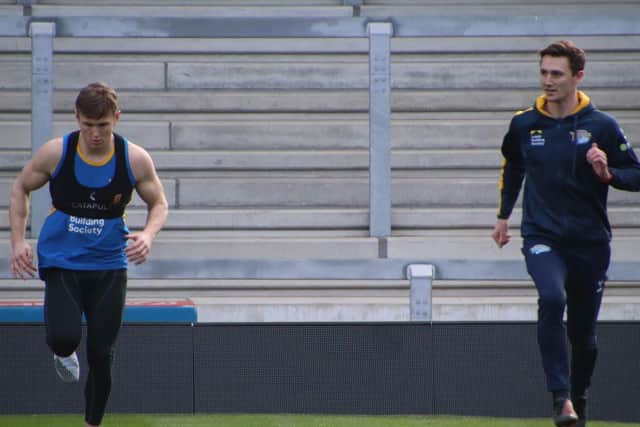 Rhinos' new physio Ryan Flanagan, right, supervises Harry Newman's first outdoor run since suffering a broken leg last September. Picture by Phil Daly/Leeds Rhinos.
