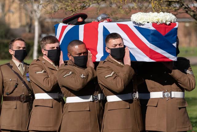 The coffin of Captain Sir Tom Moore is carried by members of the armed forces during his funeral at Bedford Crematorium. PIC: Joe Giddens/PA Wire