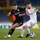 GRIT: Aston Villa's Scotland international midfielder John McGinn, left, battles it out with Leeds United's Poland international Mateusz Klich in Saturday evening's clash at Elland Road. Photo by Laurence Griffiths/Getty Images.