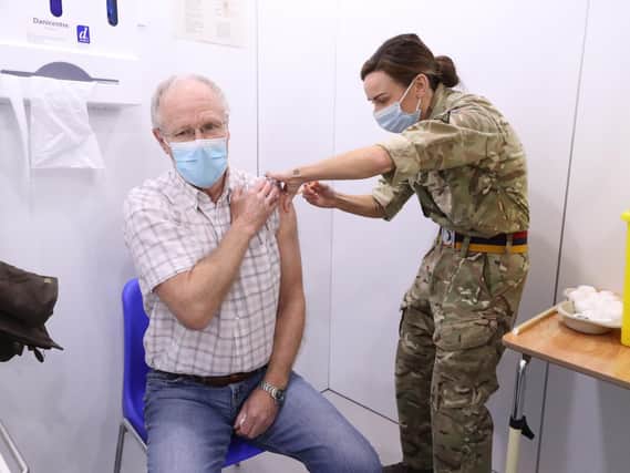 Richard Moss, aged 73, received his injection of the the Oxford/AstraZeneca coronavirus vaccine from Lance Corporal Carla Fraser, Regimental Aid Post 4th Battalion Royal Regiment of Scotland, at the Elland Road vaccination centre in Leeds (photo: PA Wire/ Danny Lawson)