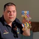 Simon Brown pictured with his own medals and those of his grandfather and great-grandfather who fought in both the World Wars in November 2019. Picture Tony Johnson.