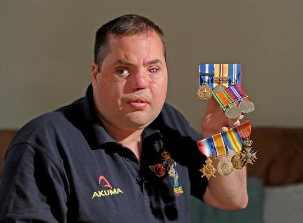 Simon Brown pictured with his own medals and those of his grandfather and great-grandfather who fought in both the World Wars in November 2019. Picture Tony Johnson.