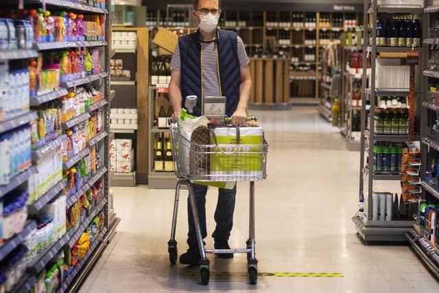 File photo of a shopper wearing a face mask in a supermarket.