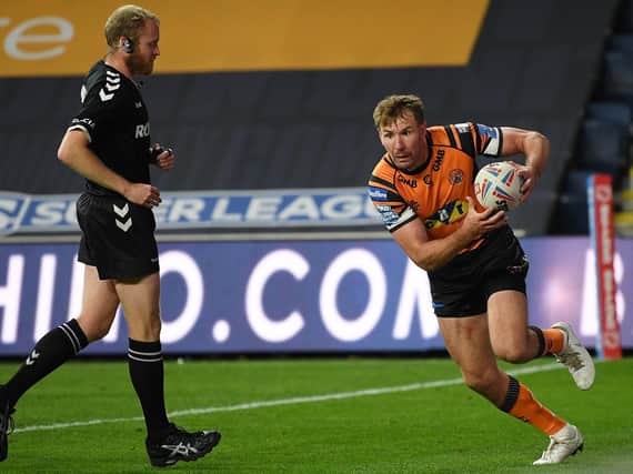 Michael Shenton scores against Salford last season as referee Robert Hicks watches on. Picture by Jonathan Gawthorpe.