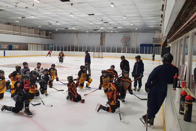 Bradford Bulldogs Under-11s and Under-13s listen to head coach Andy Brown, far right, during a practice session last year.