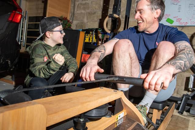 Mike Bates gets in some training for his solo Atlantic row, with son Gabe cheering him on. Picture: Bruce Rollinson
