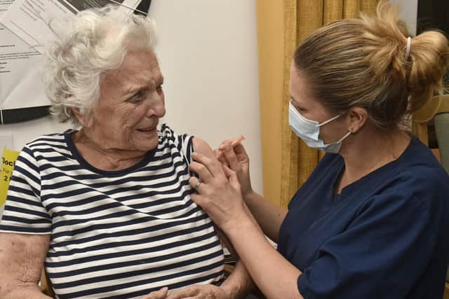 Practice nurse Leanne Wheatley giving Alexandra Court care home resident Freda Hyde, 93, her first Covid jab in January.

Photo: Steve Riding