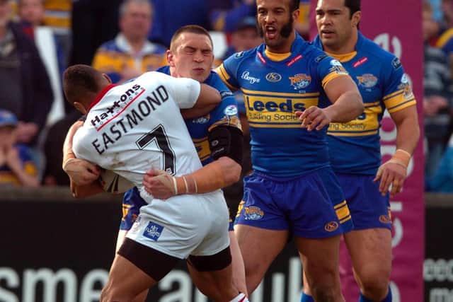 Kyle Eastmond, of St Helens, tangles with current Rhinos director of rugby Kevin Sinfield during a Super League clash in 2010, watched by Jamie Jones-Buchanan, second right, who is now a Leeds assistant-coach. Picture by Mark Bickerdike