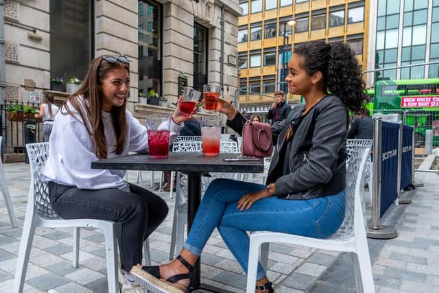 Two women enjoying a drink in the Becketts Bank Wetherspoon beer garden in summer 2020.