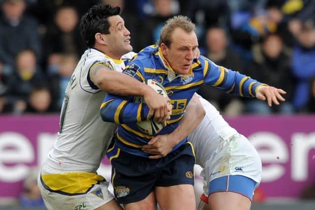 Carl Ablett is stopped by Warrington's Paul Rauhihi and Vinnie Anderson. Picture: Steve Riding.