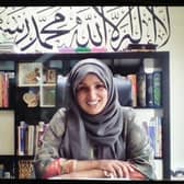 Head of sixth form Shabnam, who has four children at home, works at the kitchen table in front of a bookcase and wall art. Picture: Fran Monks