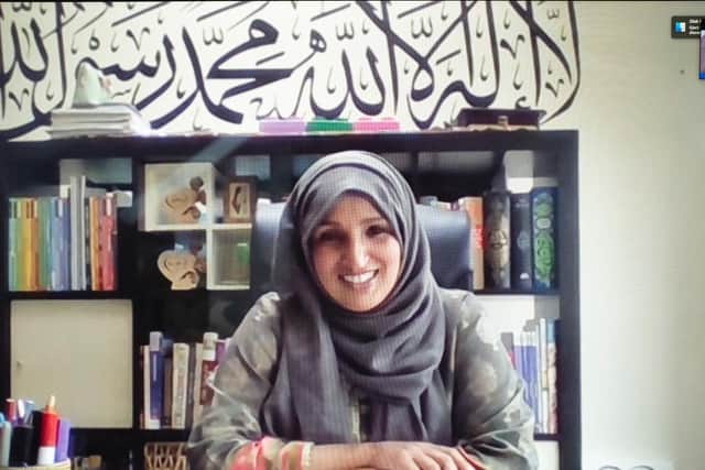 Head of sixth form Shabnam, who has four children at home, works at the kitchen table in front of a bookcase and wall art. Picture: Fran Monks
