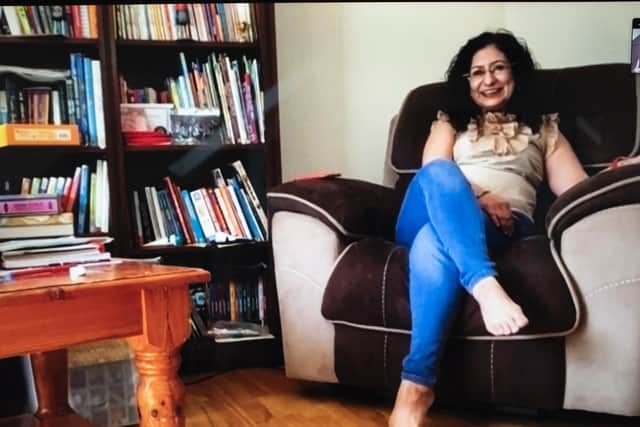 Simmi, a consultant psychiatrist with two children, sits in her favourite armchair with a table, bookshelf and books in arms reach. Picture: Fran Monks
