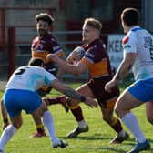 Batley Bulldogs' try scorer Luke Hooley, with ball, takes on the Rams’ defence with Jonny Campbell in support, far left. Picture: Bruce Fitzgerald.