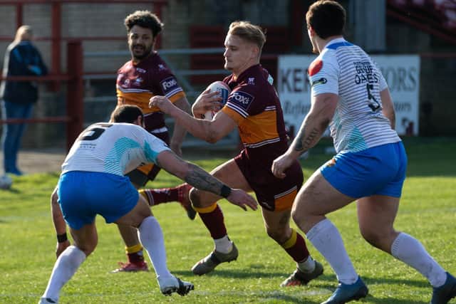 Batley Bulldogs' try scorer Luke Hooley, with ball, takes on the Rams’ defence with Jonny Campbell in support, far left. Picture: Bruce Fitzgerald.