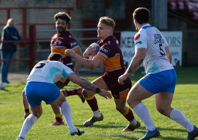 Batley Bulldogs' try scorer Luke Hooley, with ball, takes on the Rams’ defence with Jonny Campbell in support, far left. Picture: Bruce Fitzgerald.