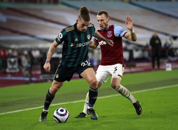 Leeds United's Kalvin Phillips and West Ham United's Vladimir Coufal battle for the ball during the Premier League match at the London Stadium, London. Picture date: Monday March 8, 2021. PA Photo. See PA story SOCCER West Ham. Photo credit should read: Ian Walton/PA Wire.

RESTRICTIONS: EDITORIAL USE ONLY No use with unauthorised audio, video, data, fixture lists, club/league logos or "live" services. Online in-match use limited to 120 images, no video emulation. No use in betting, games or single club/league/player publications.